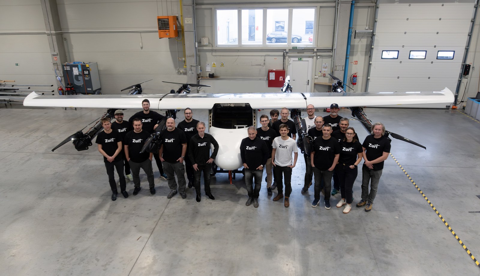 The Zuri team gathered under the wing of the full-scale demonstrator in the Prague hangar