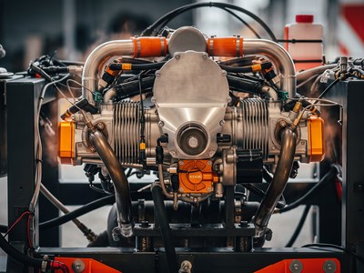 The hybrid generator engine running on its test stand, exhaust headers and instrumentation wiring in view