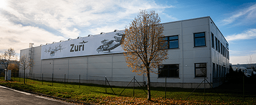 Zuri headquarters in Vestec near Prague, an aircraft graphic running across the facade