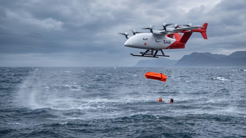 Render of a Zuri aircraft in rescue markings hovering over heavy seas, an inflatable liferaft falling to two people in the water