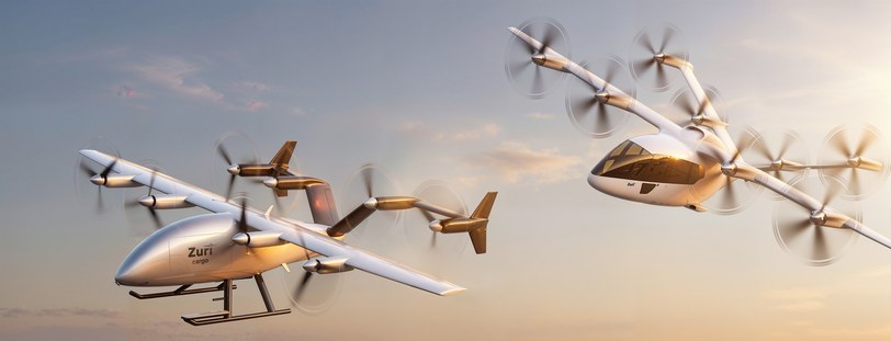 Render of two Zuri aircraft banking through a golden evening sky, rotors turning, one ahead of the other