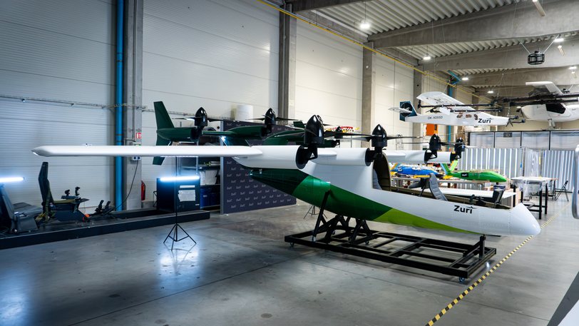 The Zuri display aircraft carrying its green and white livery on a wheeled stand in the Prague hall