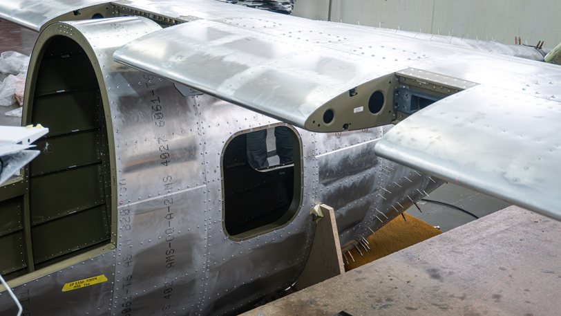 Close view of the TD 2.0 bare aluminum fuselage skin, its rivet lines and the door aperture