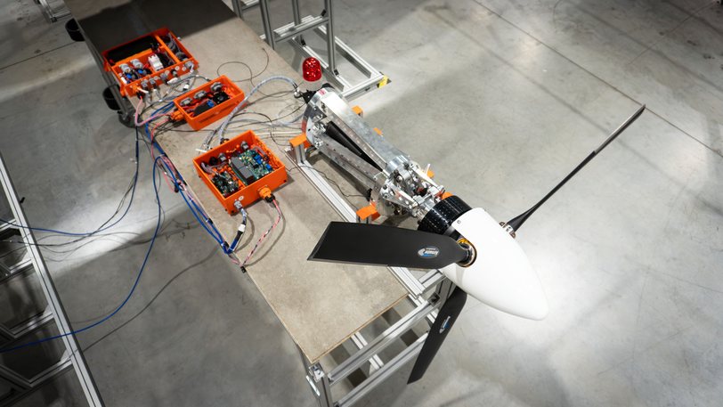 A Zuri propulsion unit on a test bench wired to orange instrumentation boxes