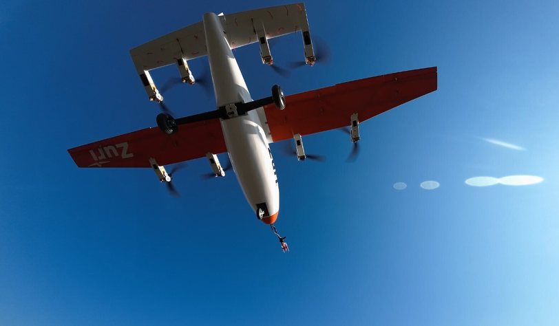 The Zuri V1NG subscale demonstrator seen from below in flight against blue sky