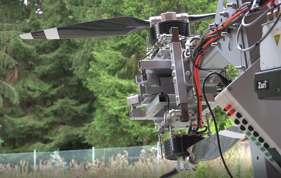 Close-up of Zuri Hybrid VTOL propulsion system during ground testing, showcasing electric motor, propeller blades, and wiring components.