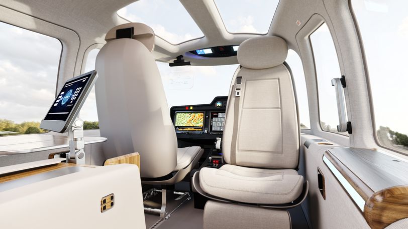 Interior view of ZURI hybrid VTOL aircraft showcasing sustainable seating, panoramic windows, and advanced flight control systems