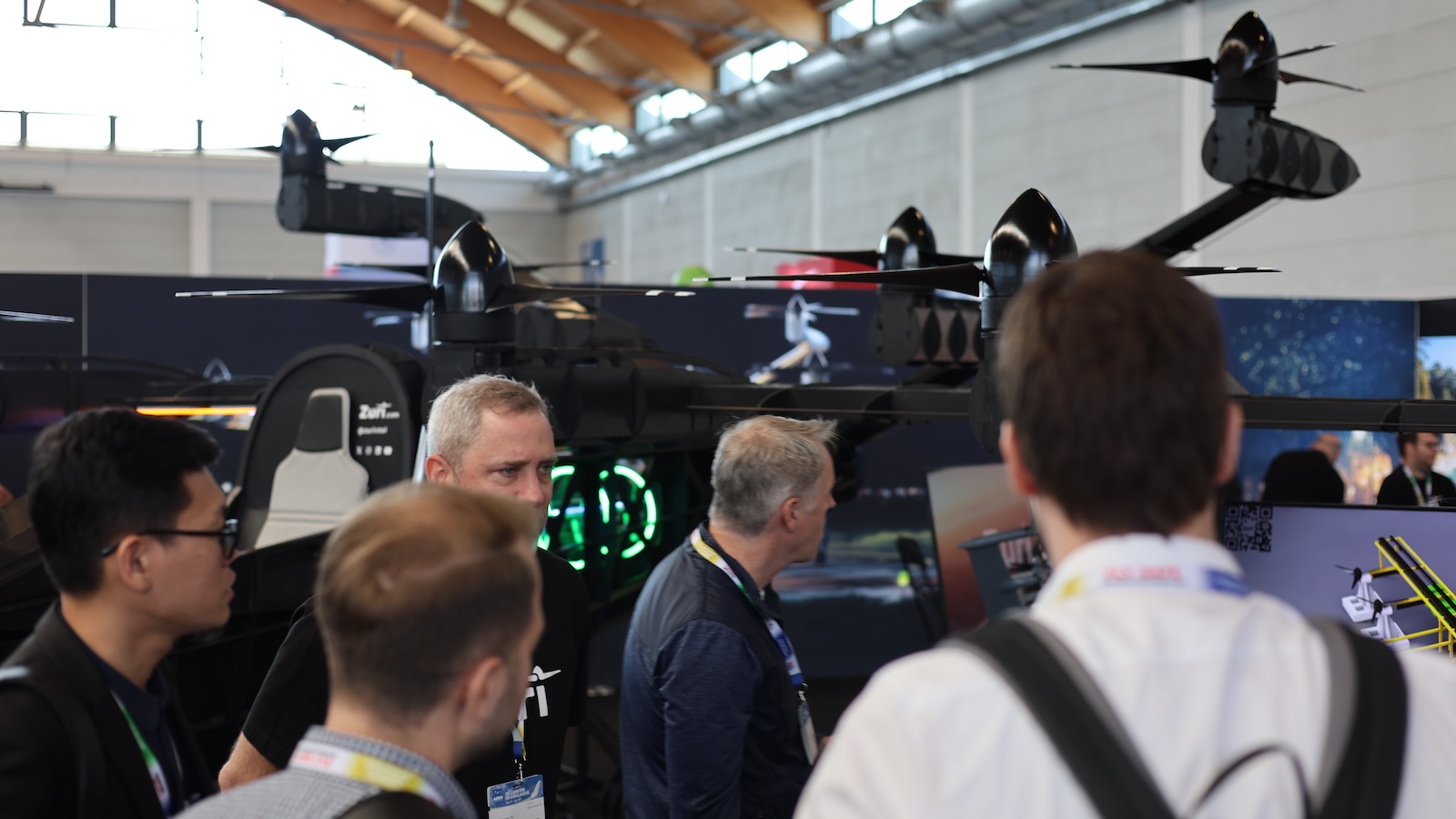 Zuri team members engage in conversation with attendees at AERO Friedrichshafen 2025, discussing hybrid VTOL innovations