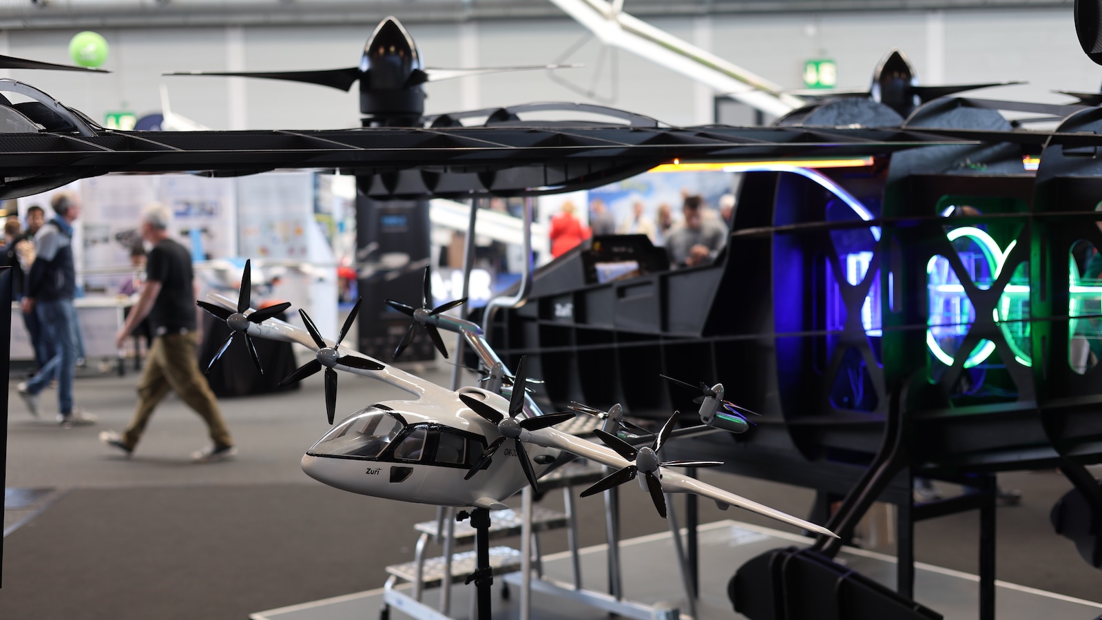 Zuri Hybrid VTOL ground testbed Skeleton at AERO Friedrichshafen 2025 showcasing spinning propellers and illuminated hybrid-electric powertrain components