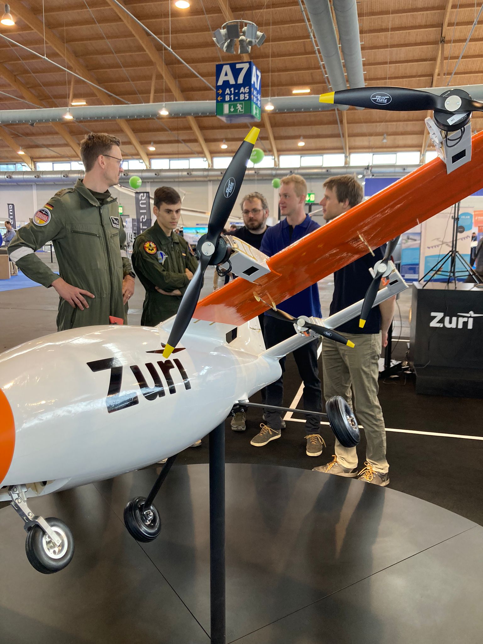 The Zuri team presenting the 3-metre V1NG demonstrator on the stand at AERO Friedrichshafen 2025